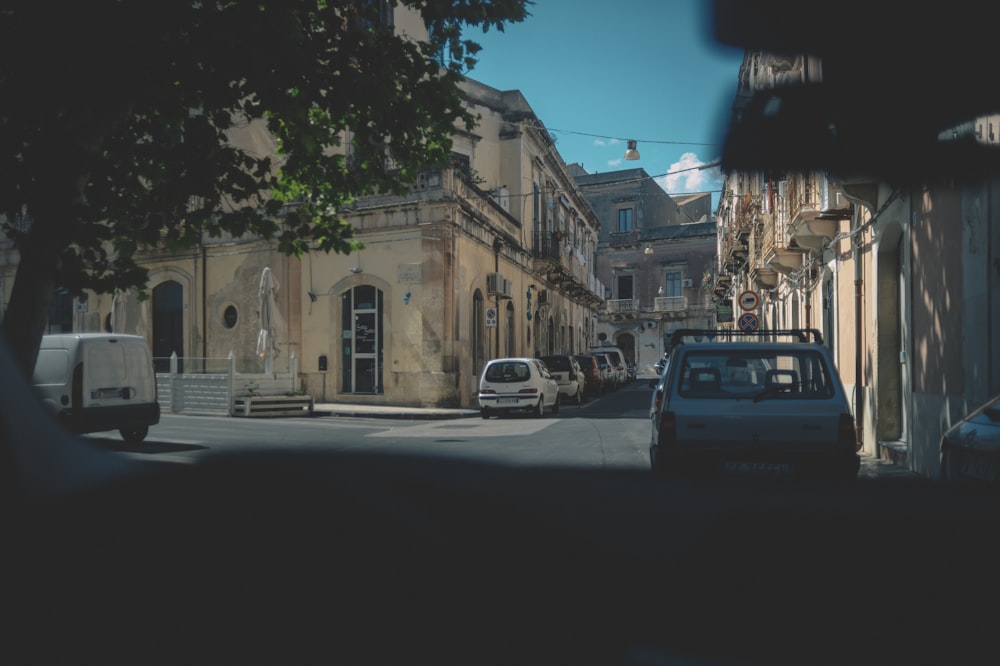 a car parked on the side of a road next to a building