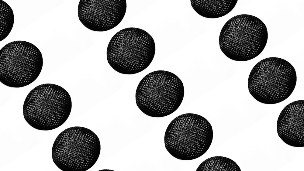 a bunch of black balls on a white background