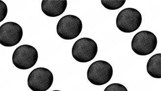 a bunch of black balls on a white background