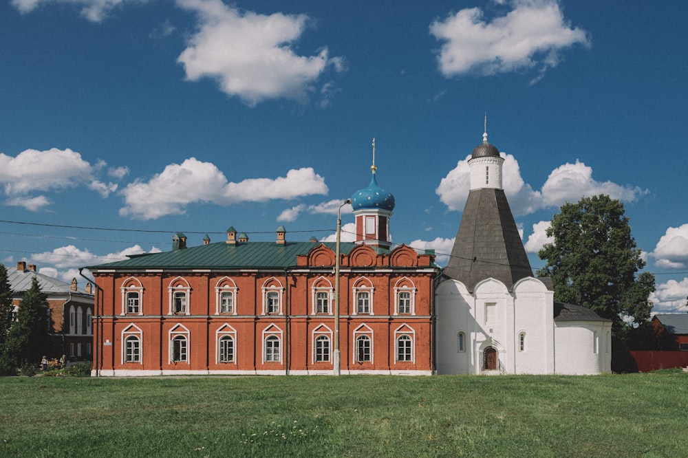 a large red building with a green roof