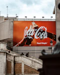 a giant coca cola advertisement on the side of a building