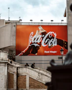 a giant coca cola advertisement on the side of a building