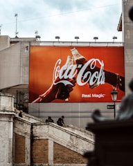 a giant coca cola advertisement on the side of a building