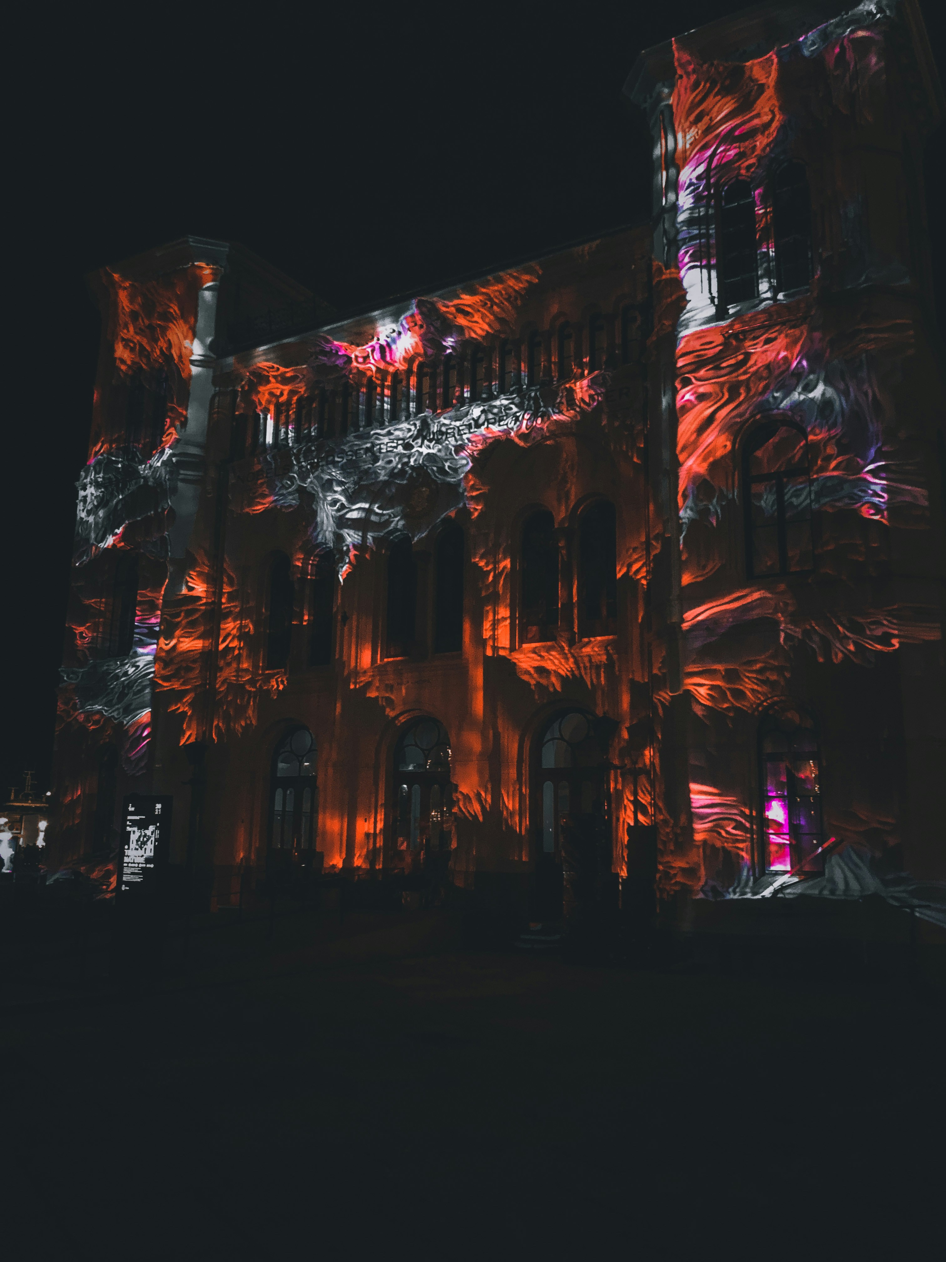 a large building lit up with red lights