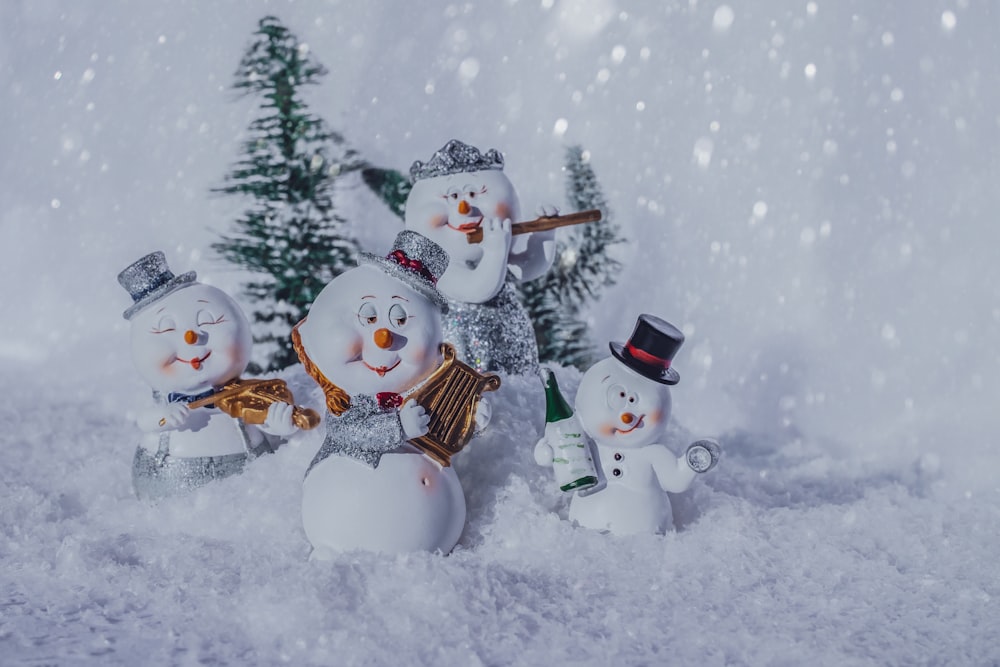 a group of snowmen standing in the snow