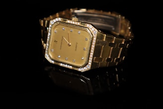 a close up of a watch on a black surface