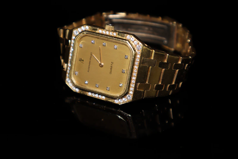 a close up of a watch on a black surface