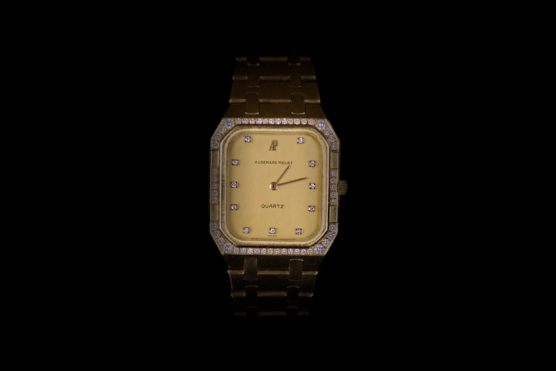 a gold watch with diamonds on the face