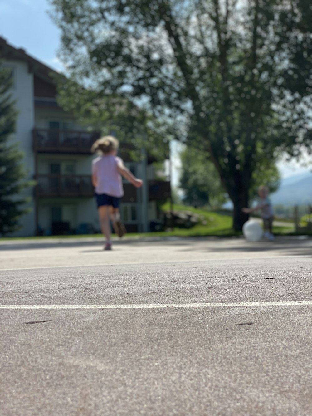 a young girl riding a skateboard down a street