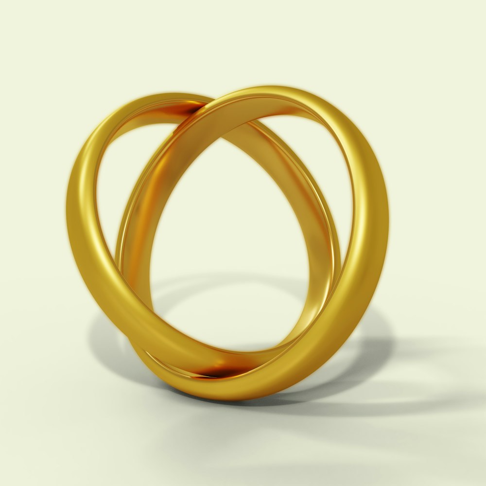 a couple of gold rings sitting on top of each other