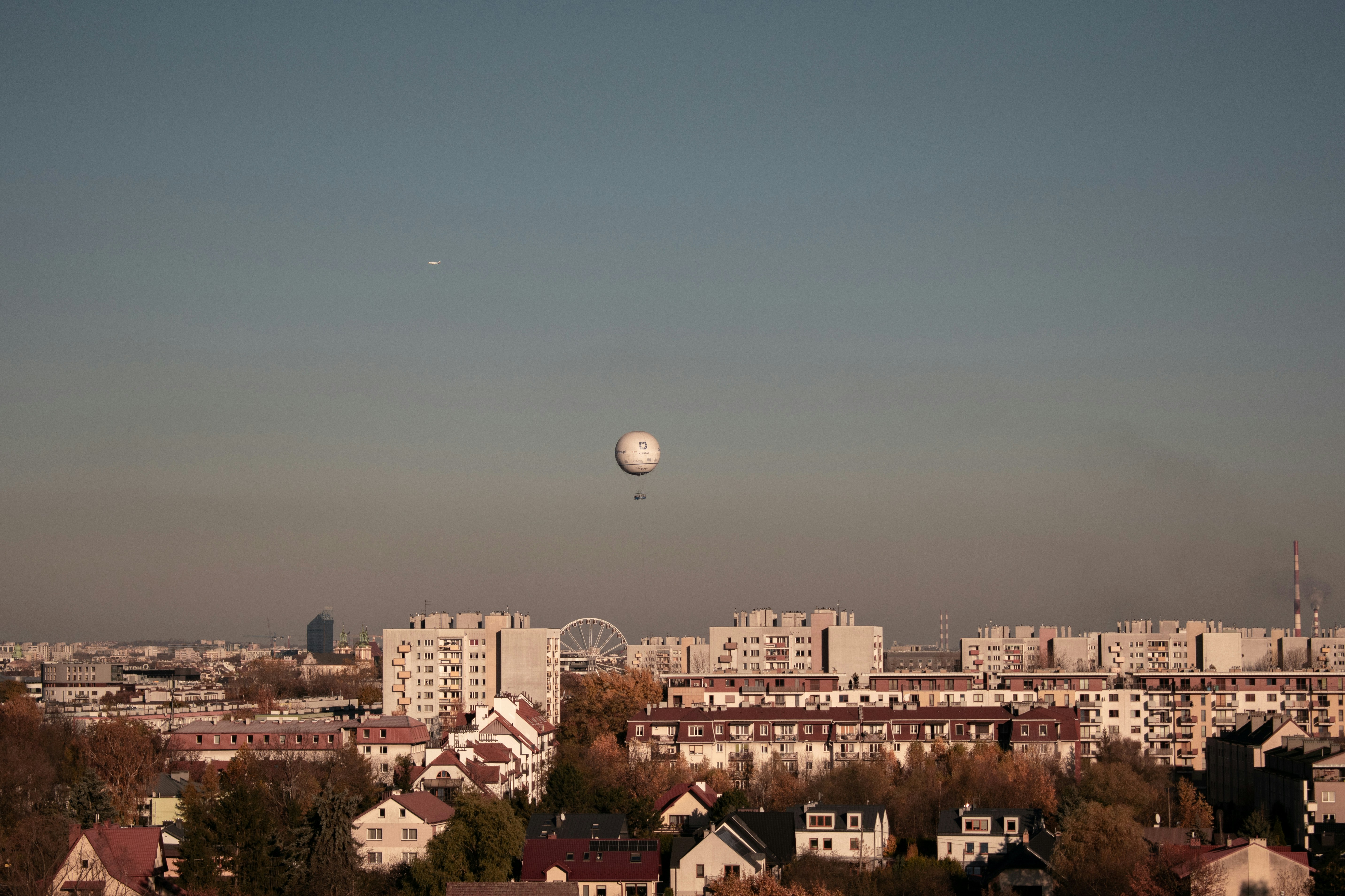 a view of a city with a balloon in the sky