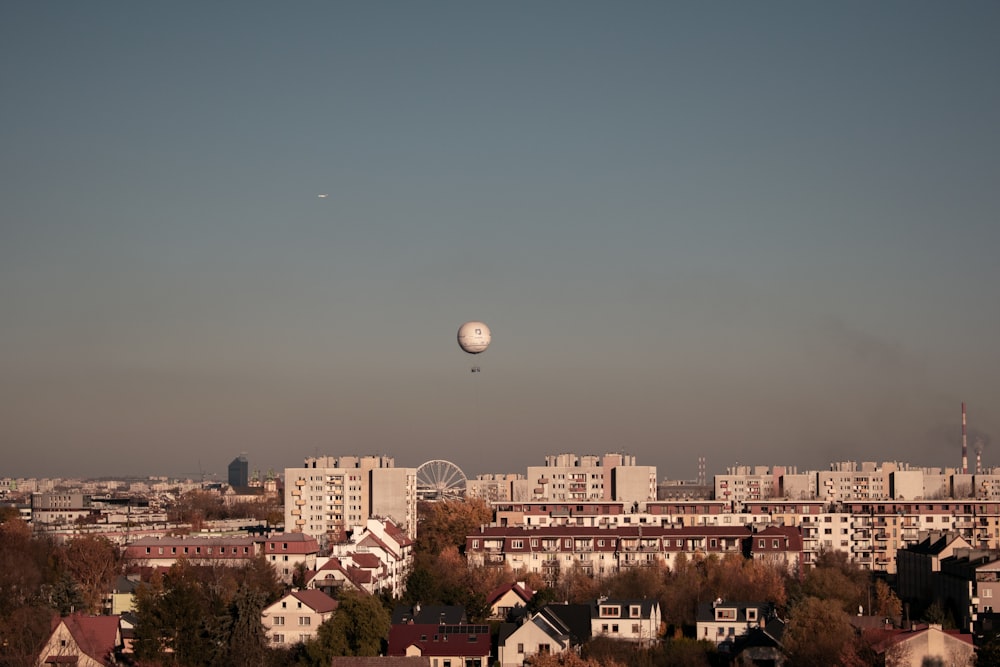 a view of a city with a balloon in the sky