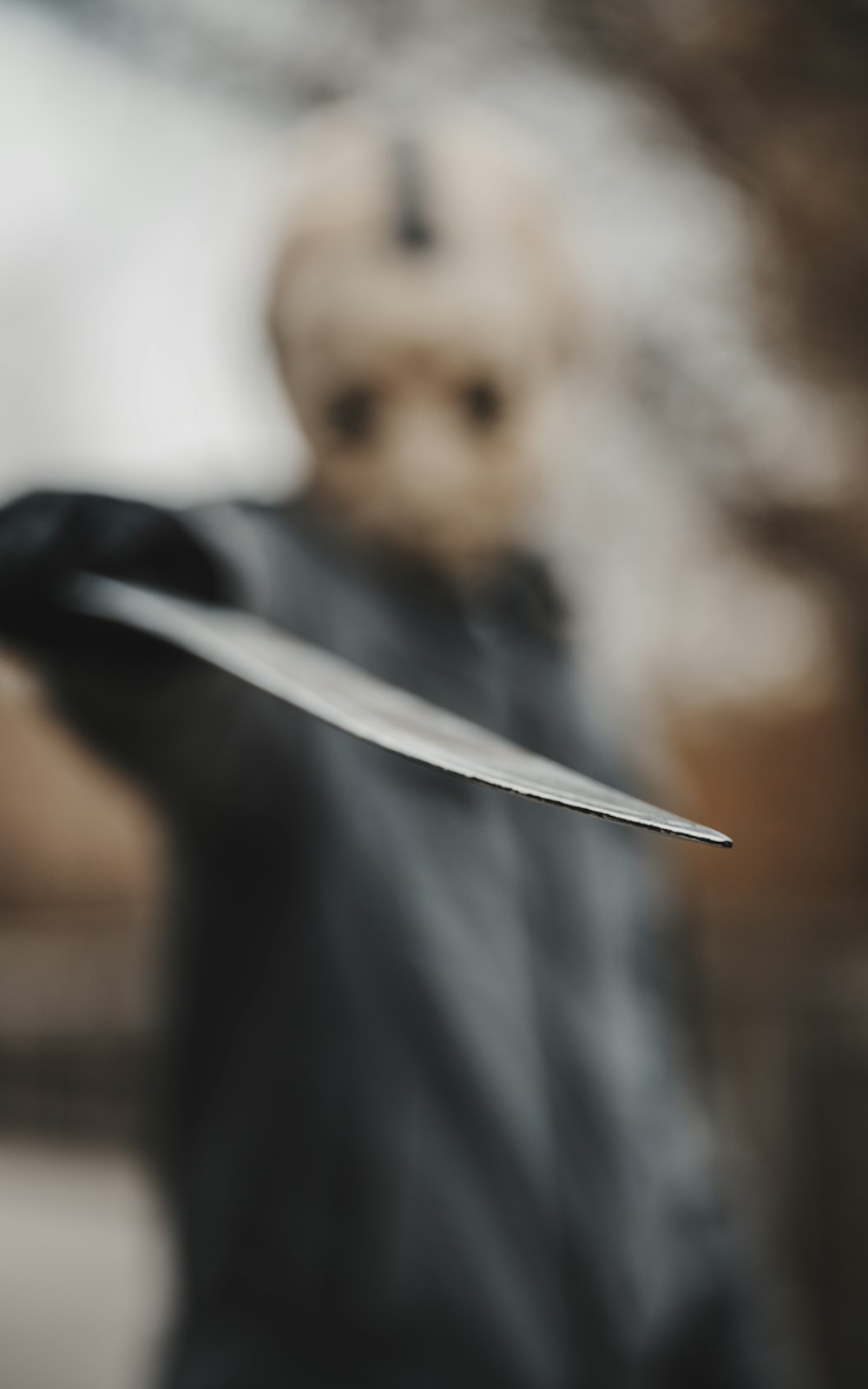a blurry image of a person holding a knife