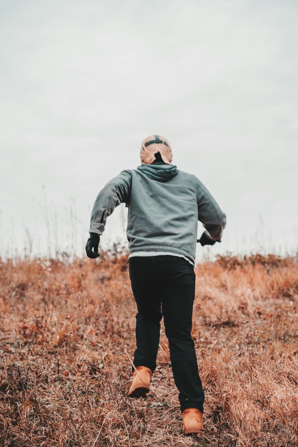 a man standing in a field with his back to the camera