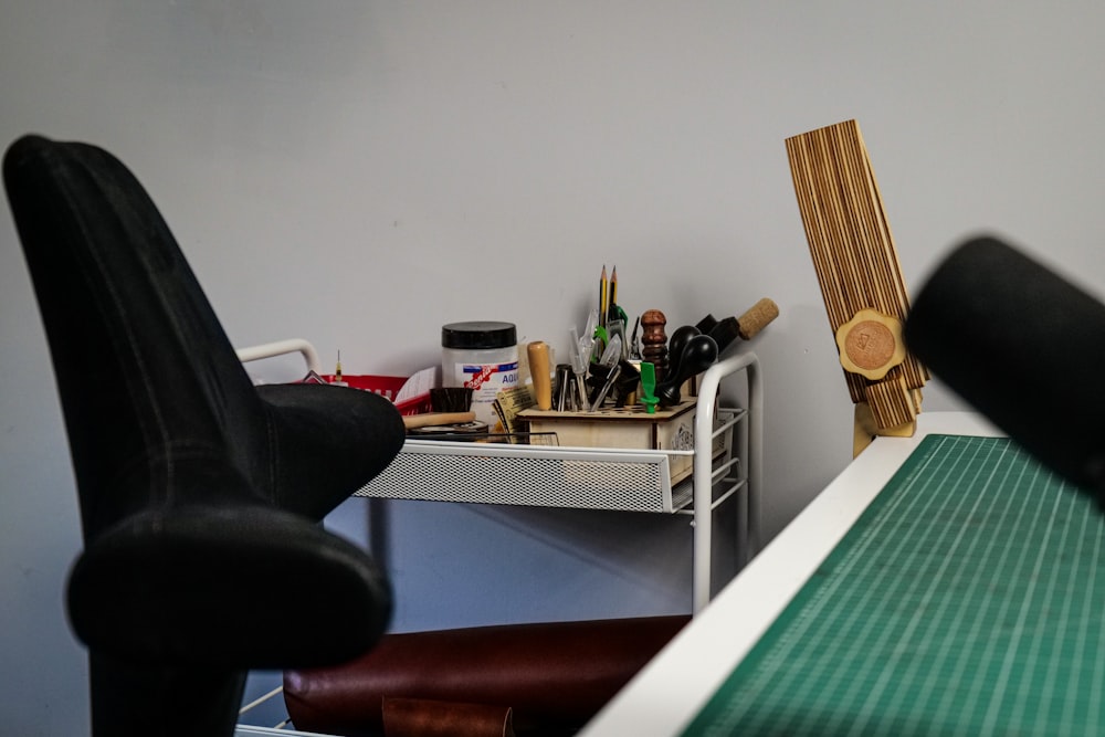 a room with a desk, chair, and sewing machine