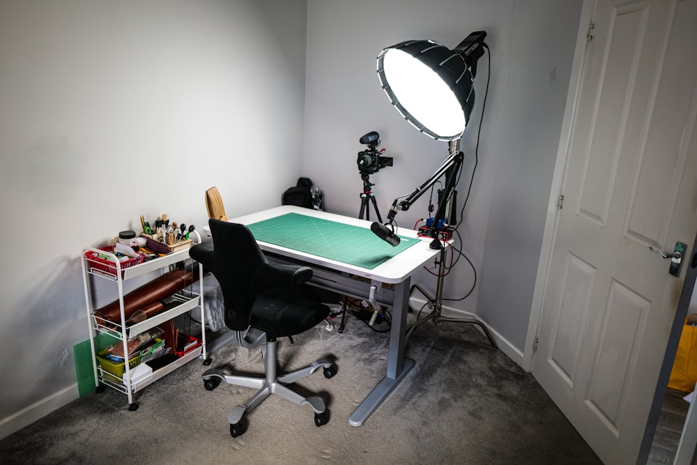 a room with a desk, chair, and light in it