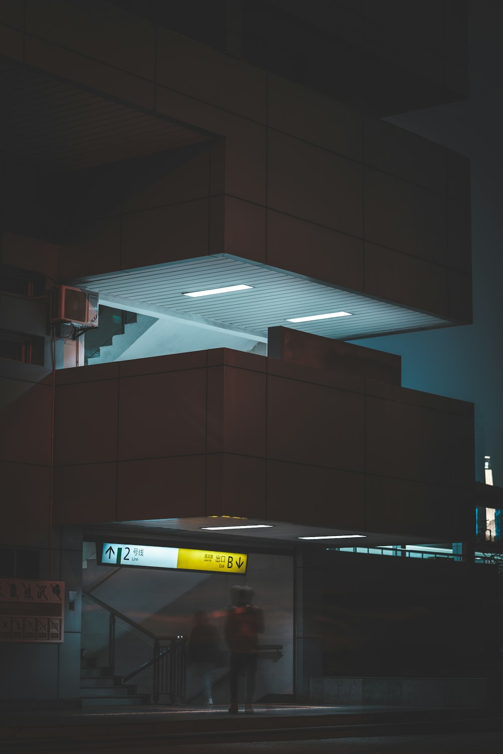 a person standing in front of a building at night