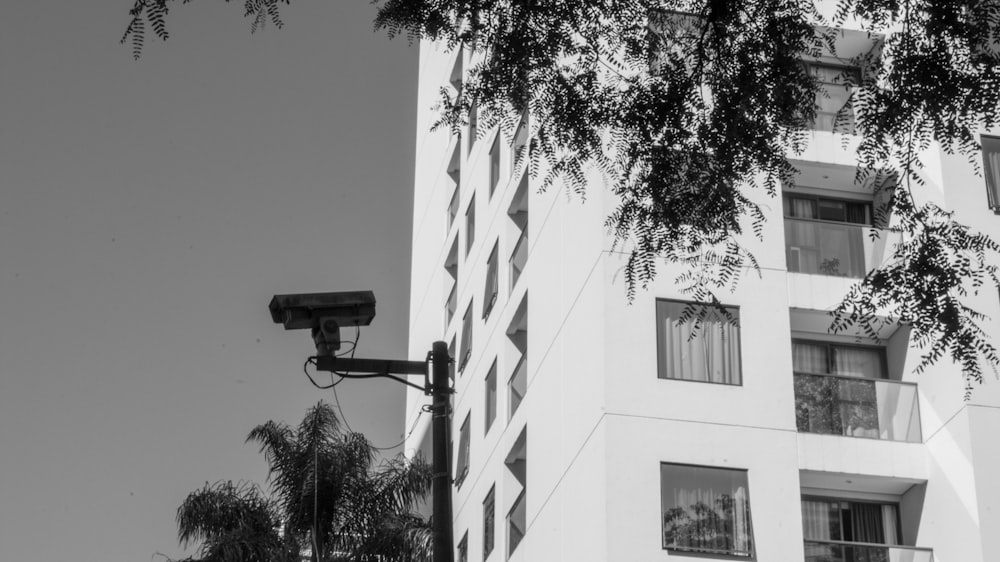 a black and white photo of a building with a security camera