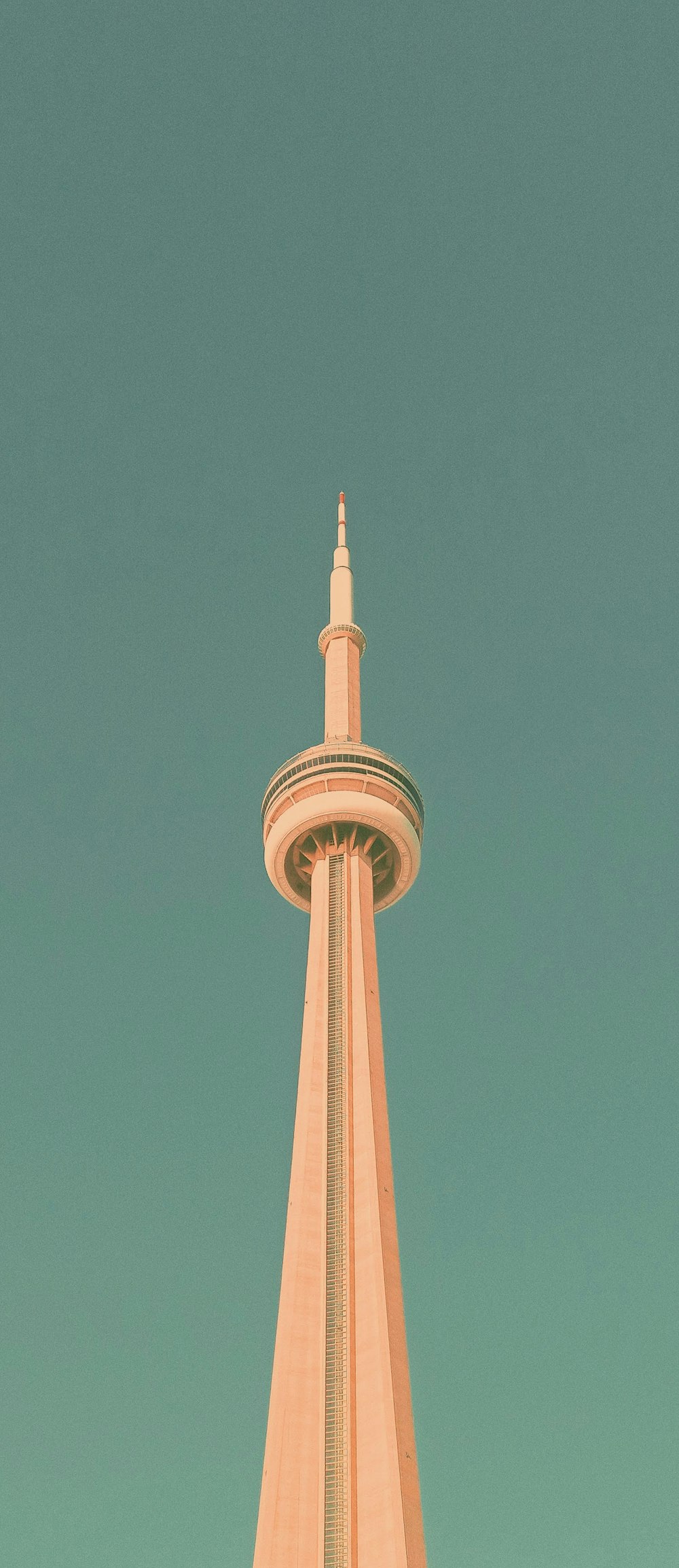 a very tall tower with a clock on it's side