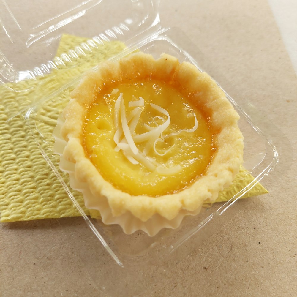 a pastry in a plastic container on a table