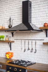 a kitchen with a stove top oven next to a counter