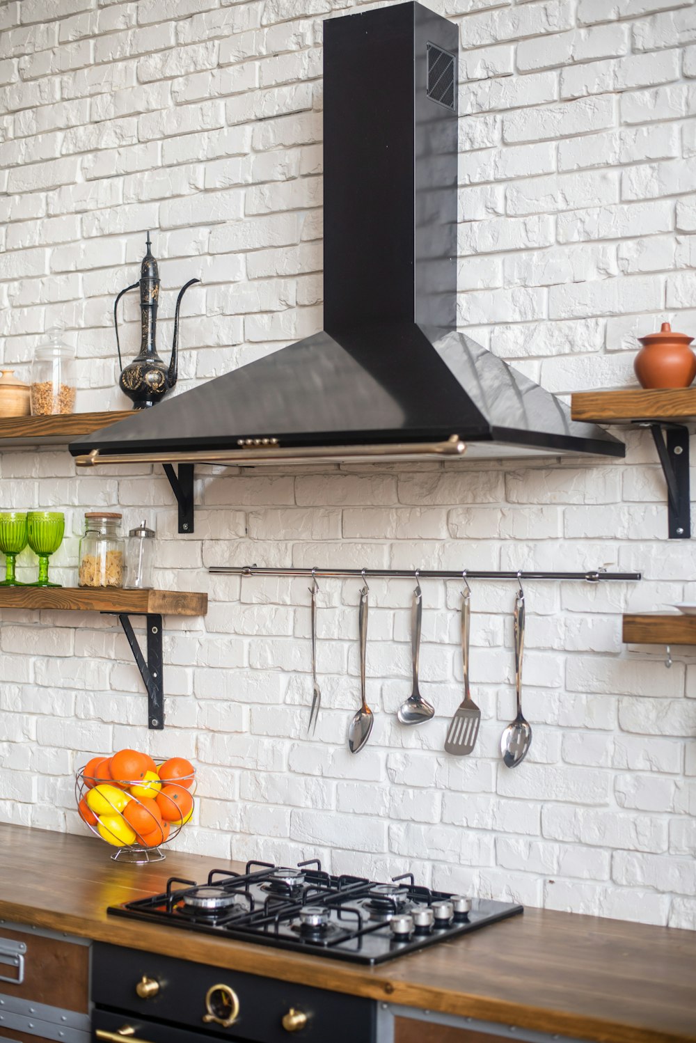 a kitchen with a stove top oven next to a counter