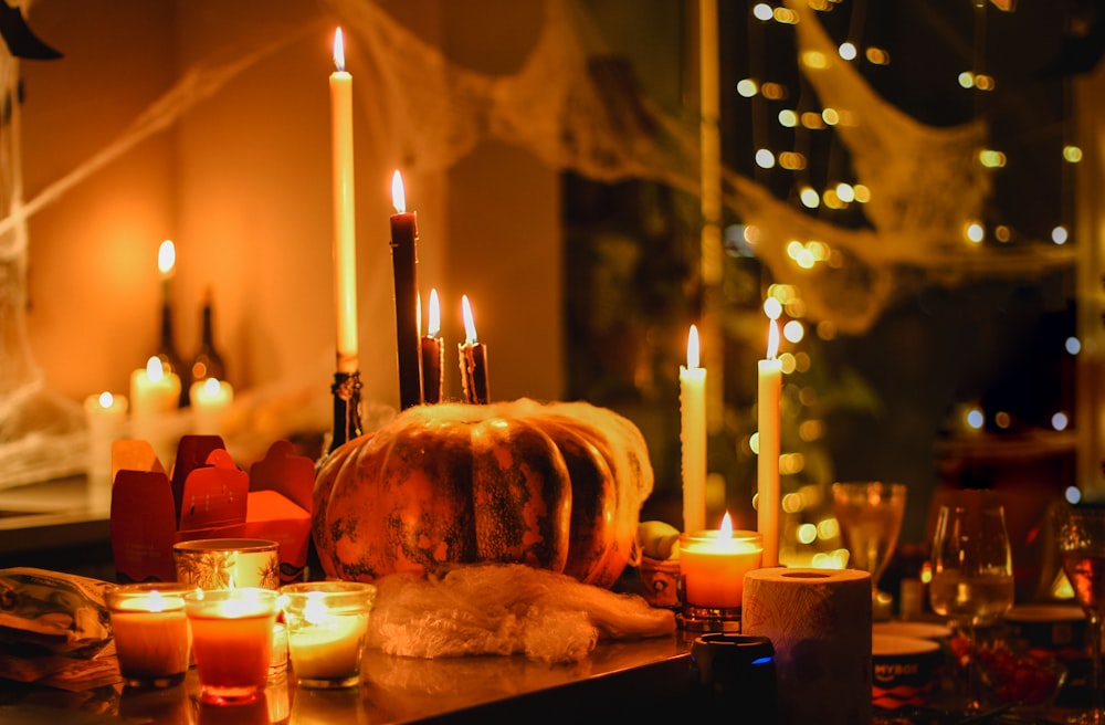 a table topped with candles and a stuffed animal