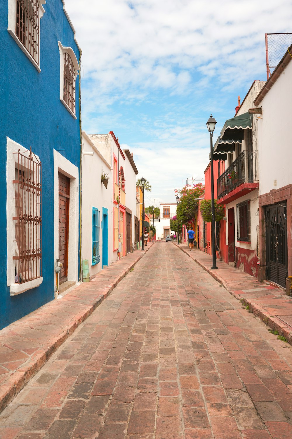 a cobblestone street lined with colorful buildings