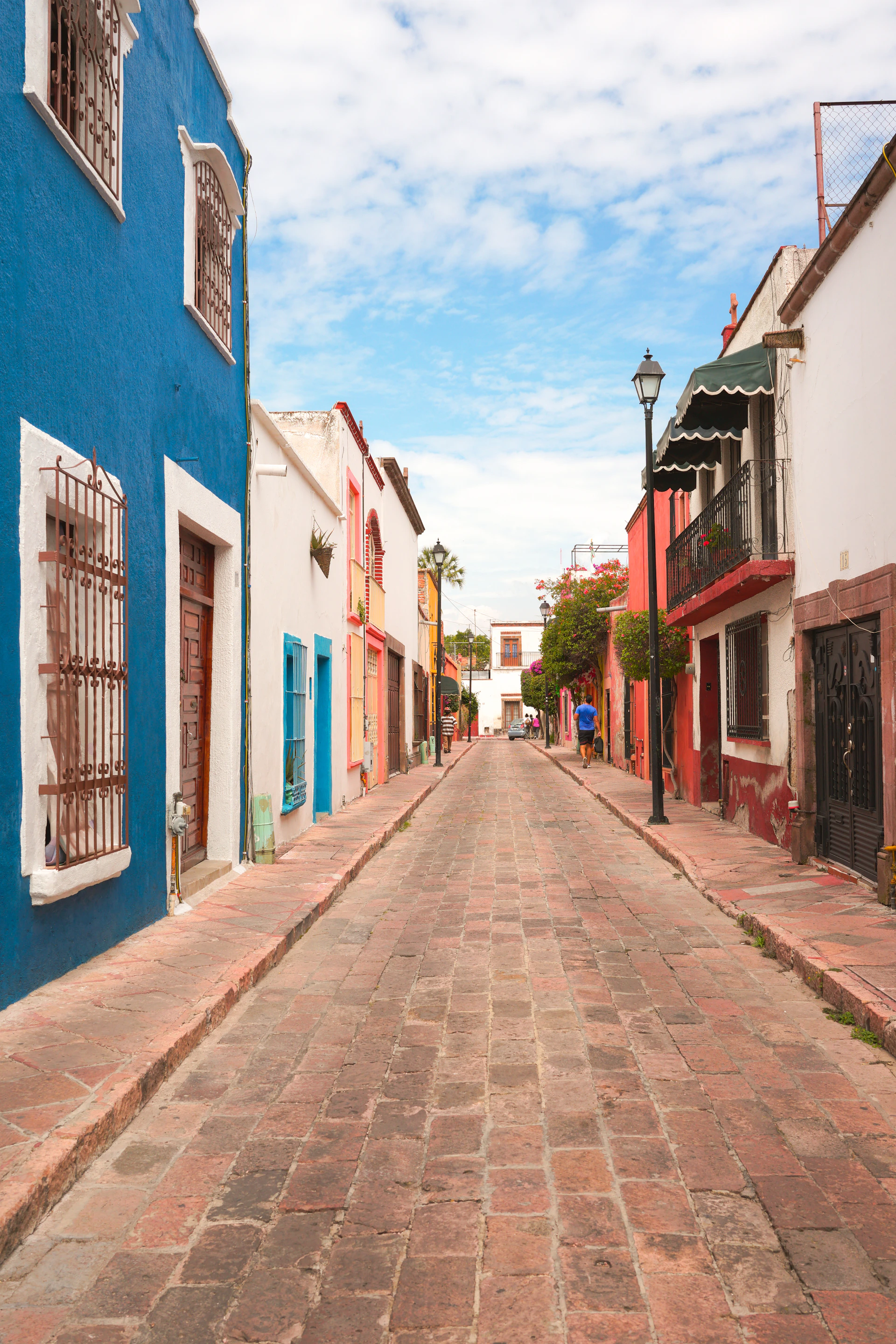 a cobblestone street lined with colorful buildings