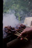 a person is cooking food on a grill
