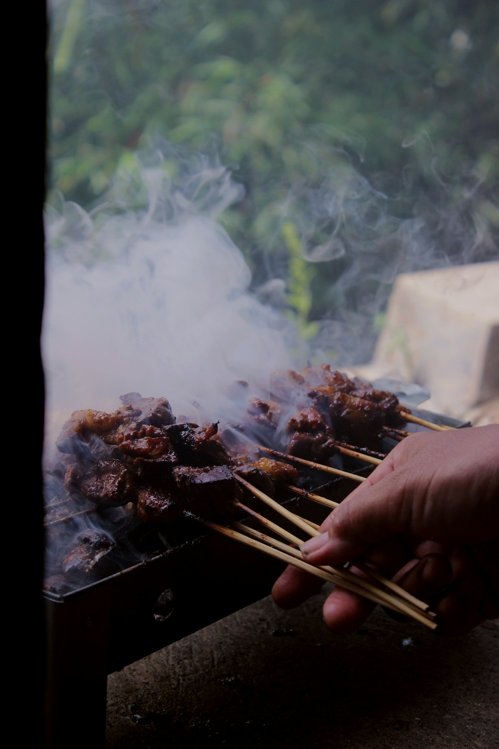 a person is cooking food on a grill