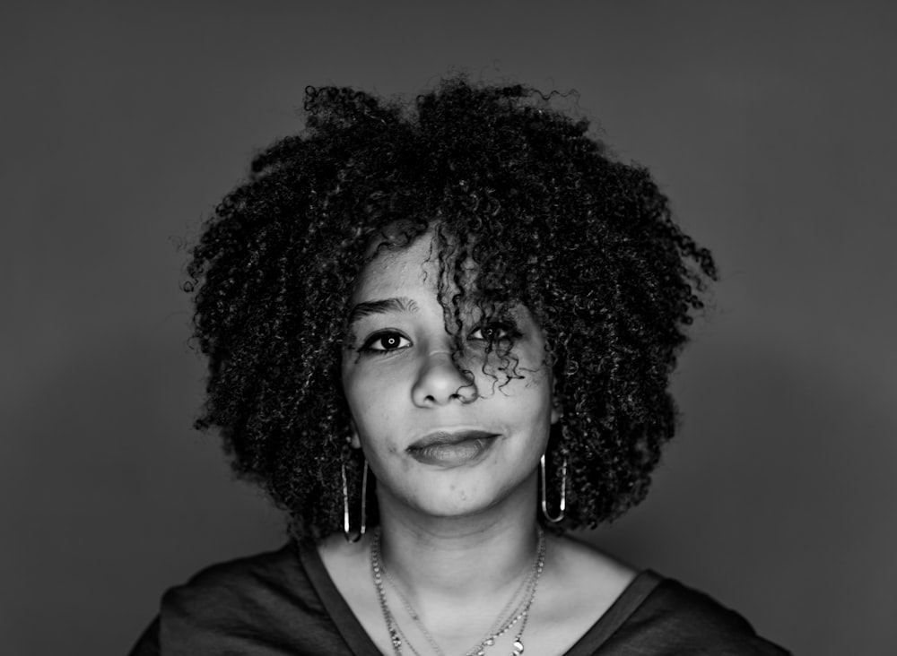 a black and white photo of a woman with curly hair