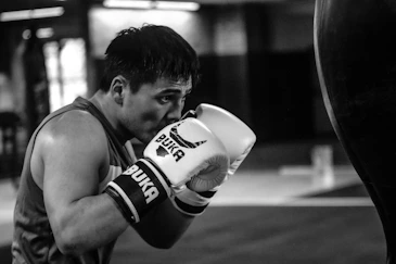 a man in a gym wearing boxing gloves