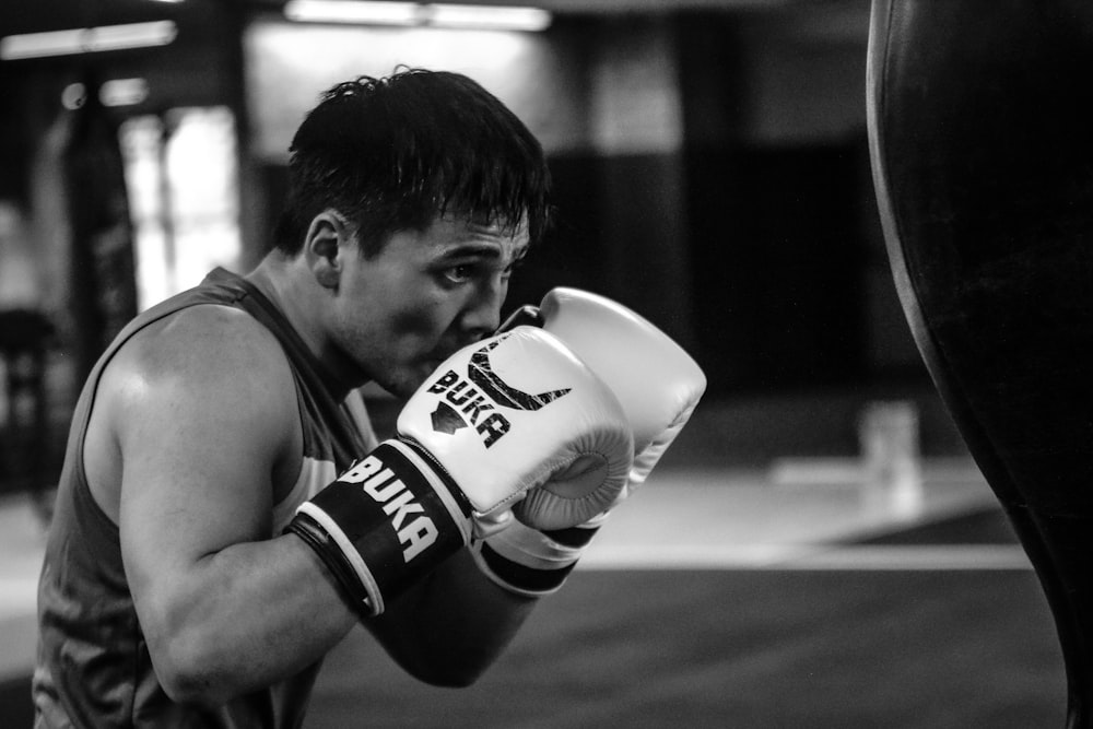 a man in a gym wearing boxing gloves