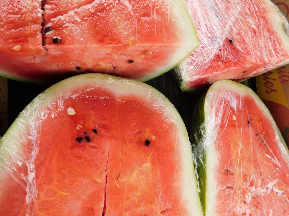 a pile of sliced watermelon sitting on top of a table