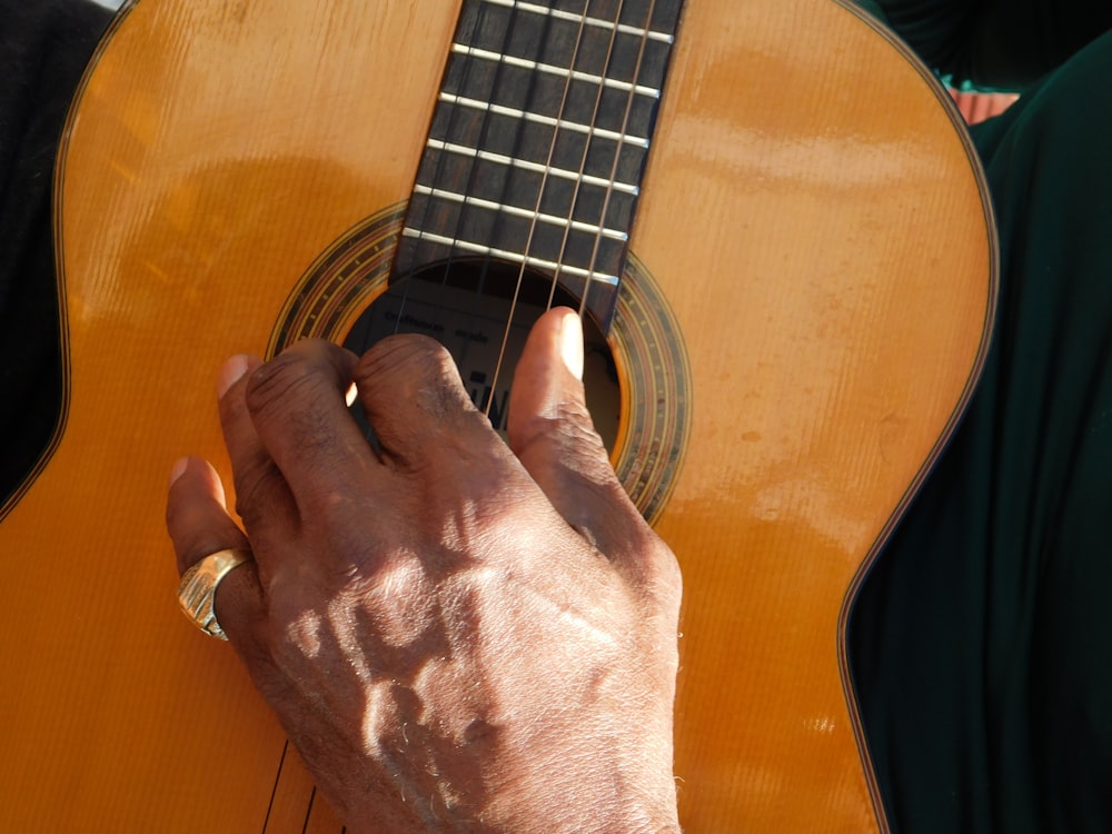 a close up of a person playing a guitar