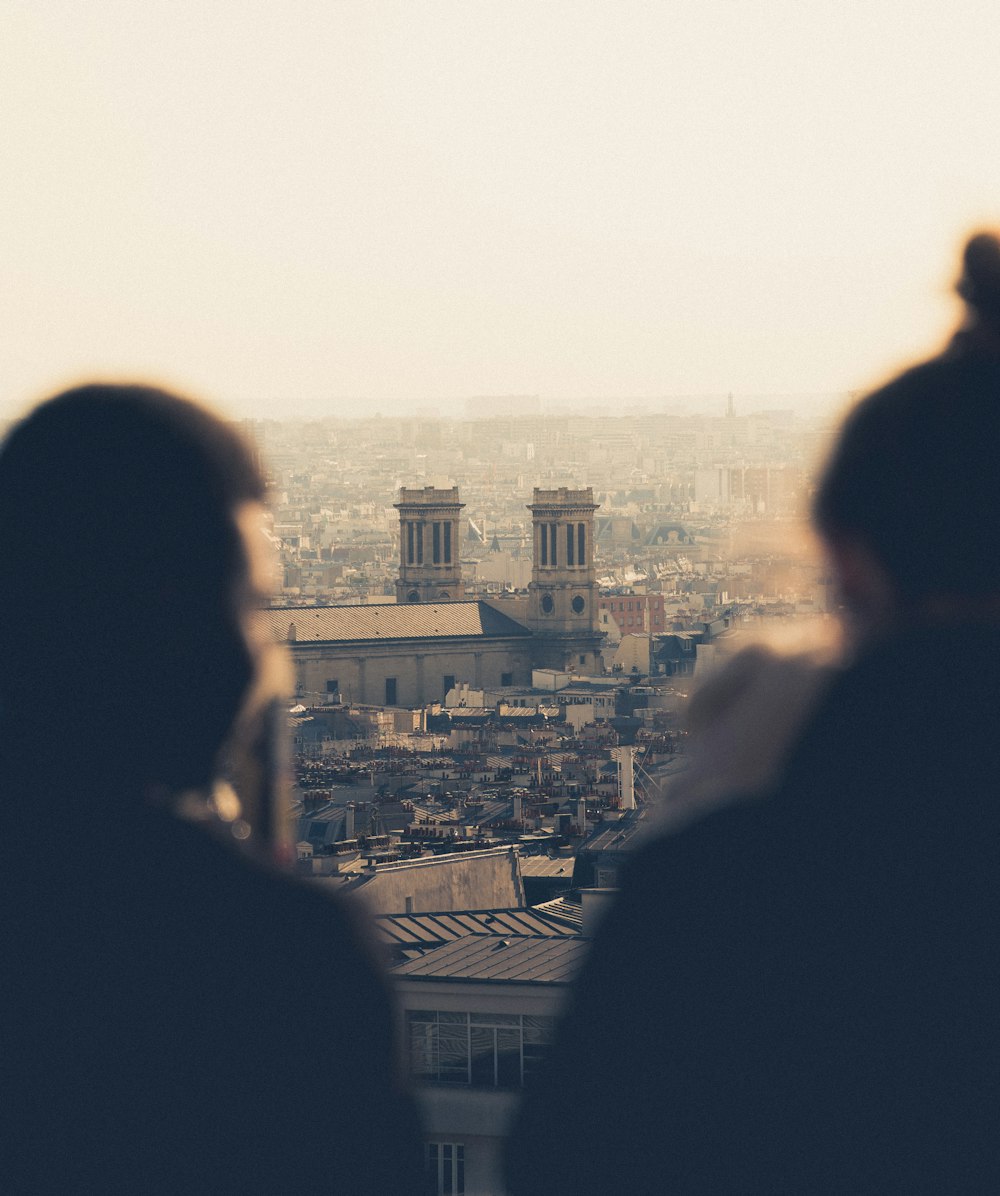 a couple of people that are looking at a city