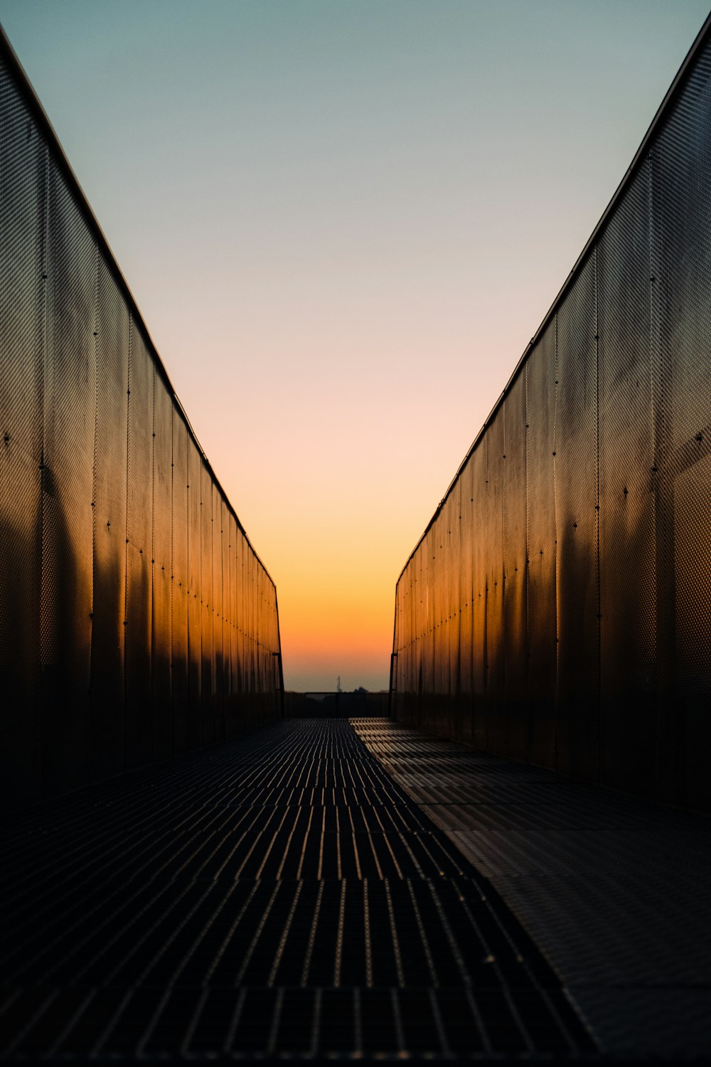 the sun is setting behind two large buildings