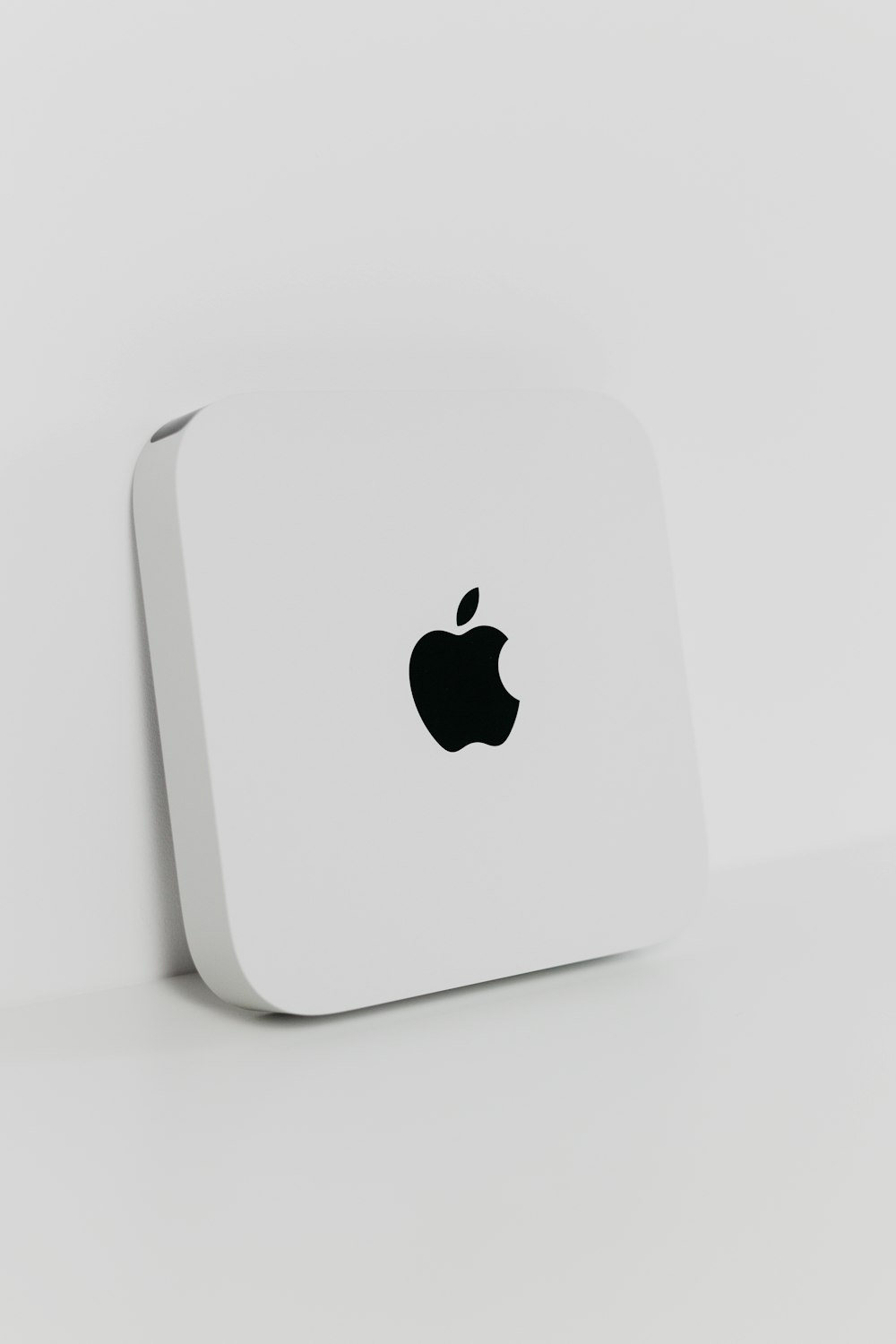 a close up of an apple product on a white surface