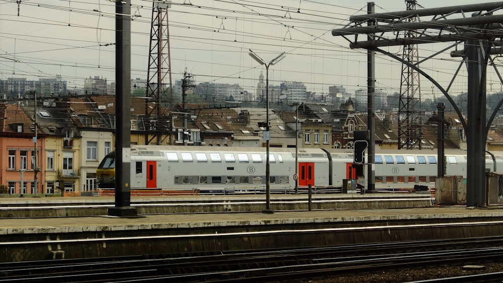 a train traveling down train tracks next to tall buildings