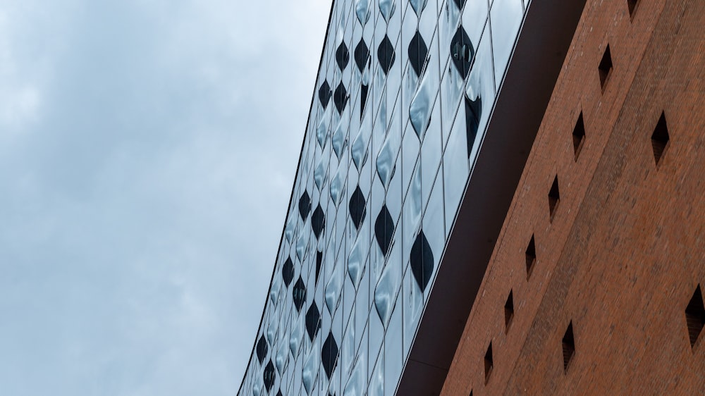 a tall brick building next to a tall glass building