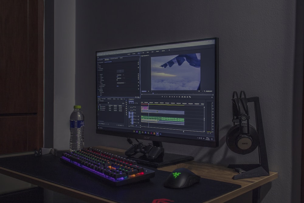 a computer monitor sitting on top of a wooden desk