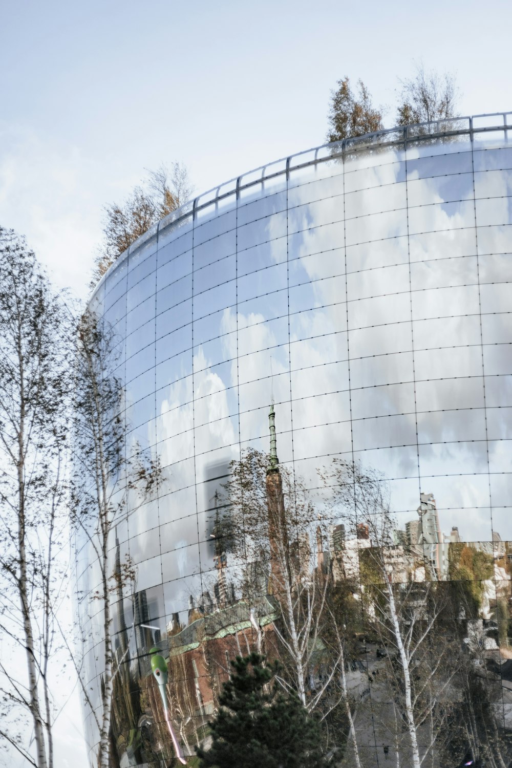 a reflection of a city in a glass building