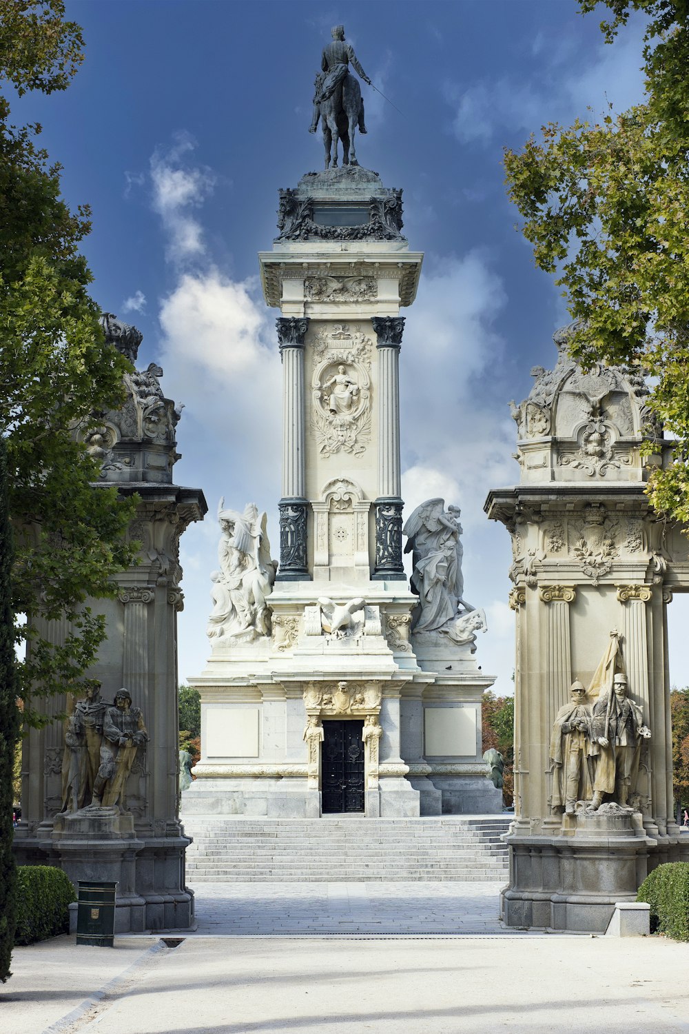 a statue of a man on a horse in a park