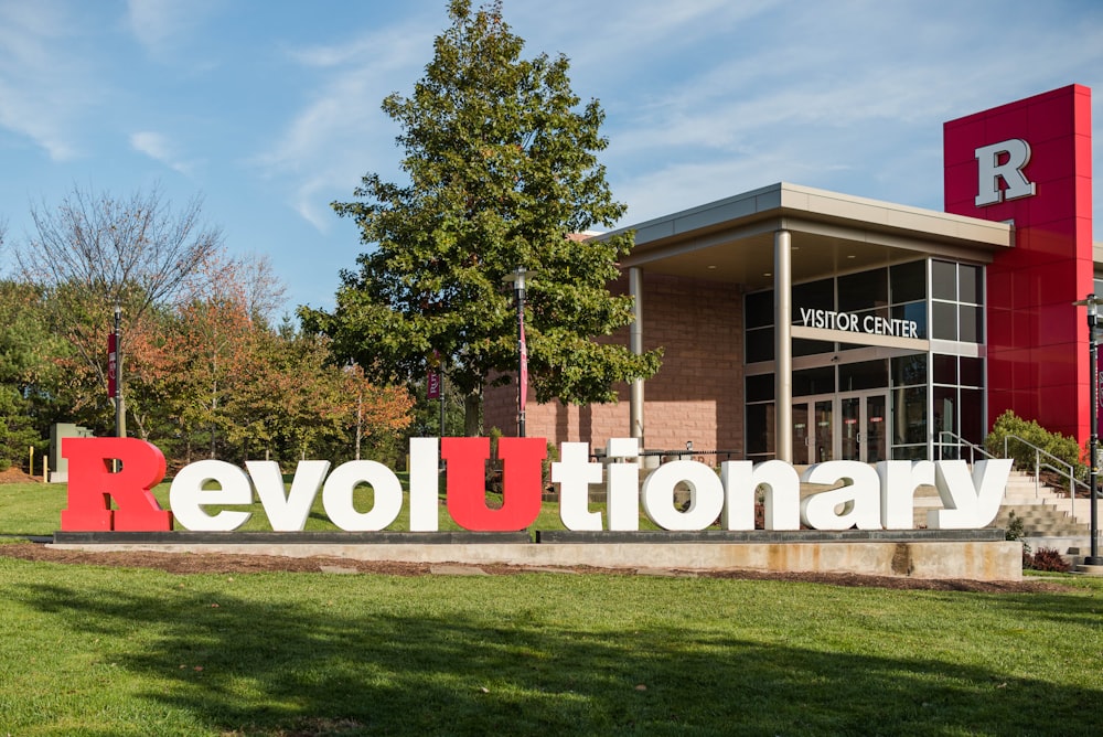 a sign that says revolution in front of a building