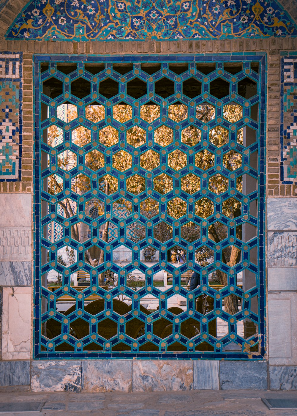 a decorative window with a reflection of a building