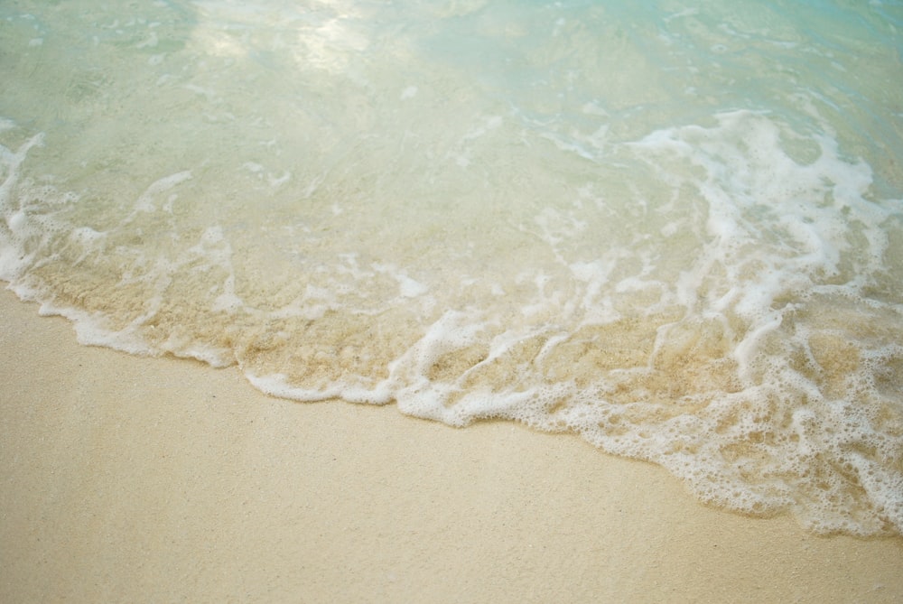 a close up of a wave on a beach