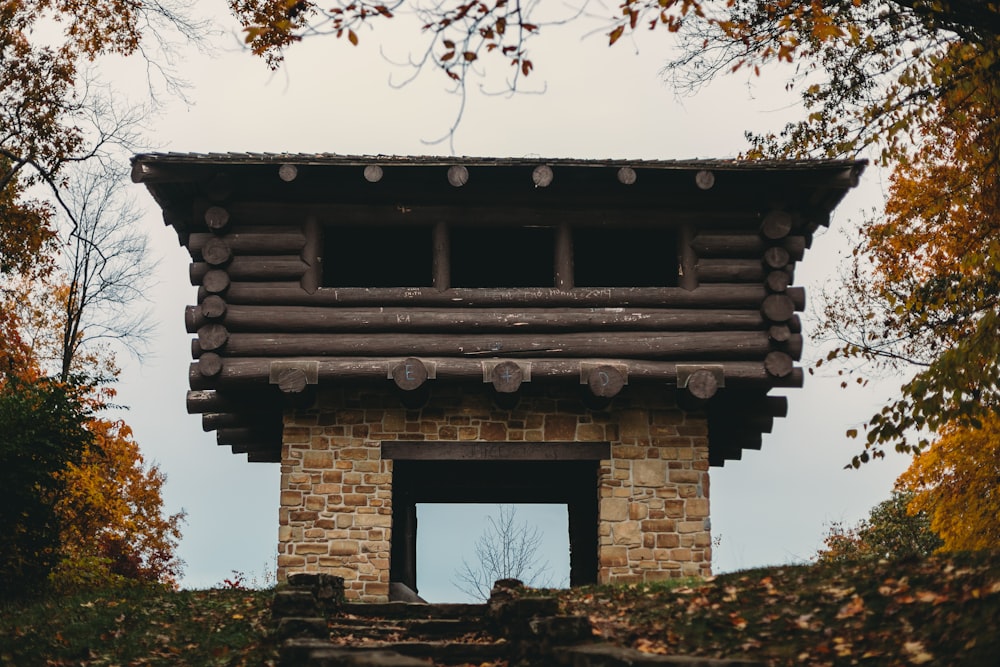 a tall wooden structure sitting in the middle of a forest