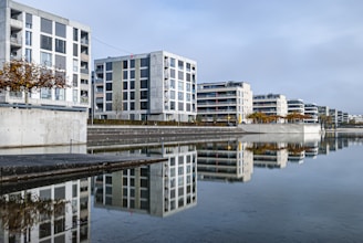 Modern apartment building with balconies overlooking a peaceful lake in Pátzcuaro.