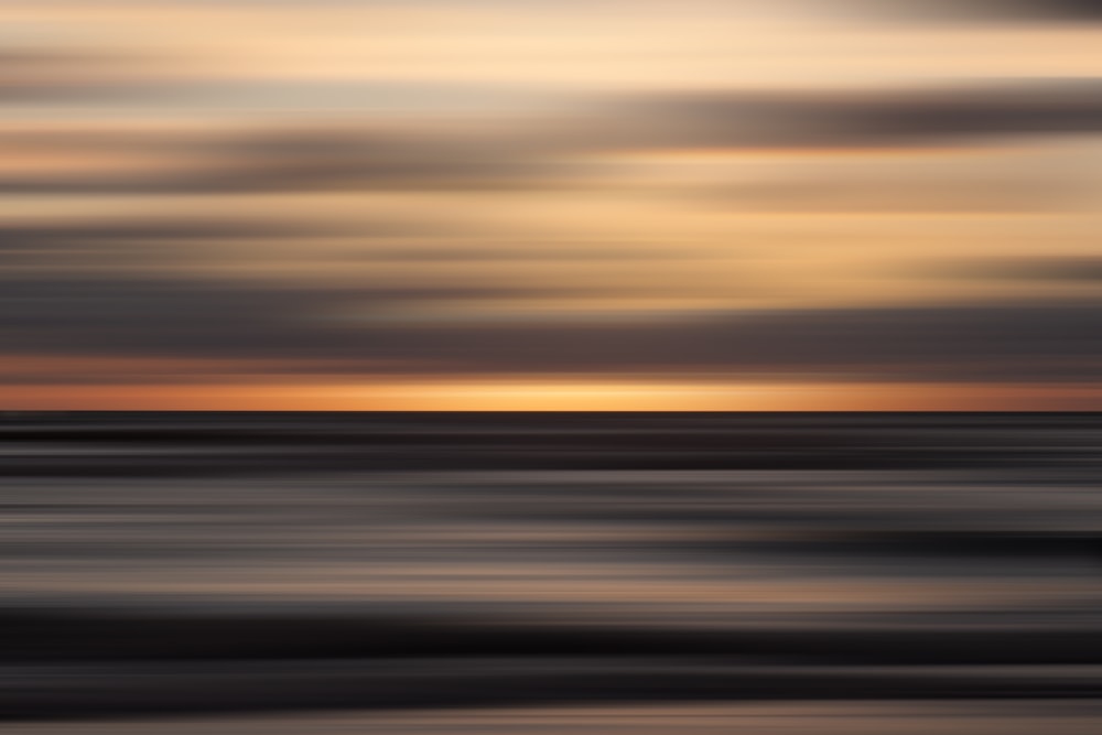 a blurry photo of a sunset over the ocean